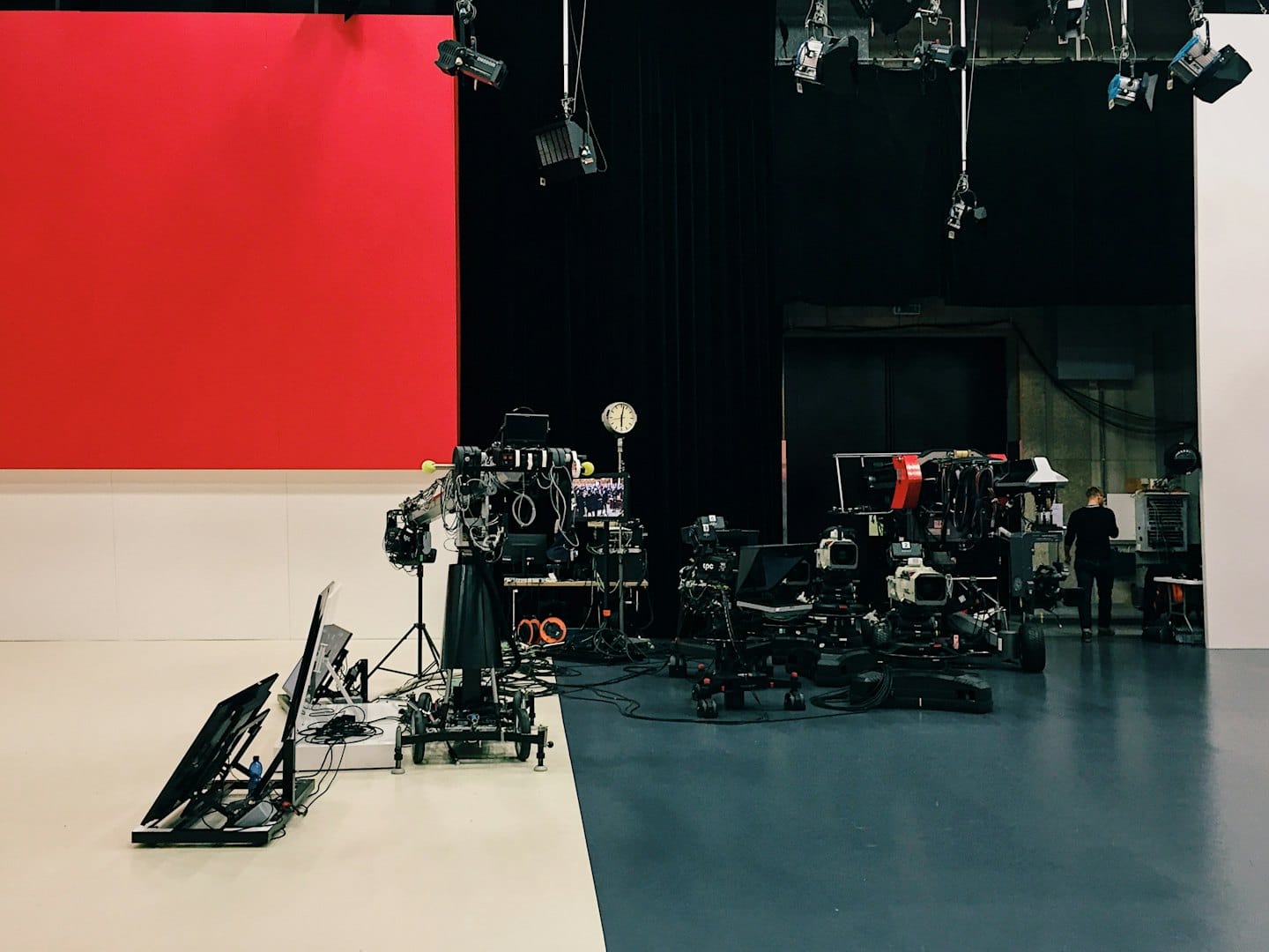 Television studio with broadcast cameras and production equipment.