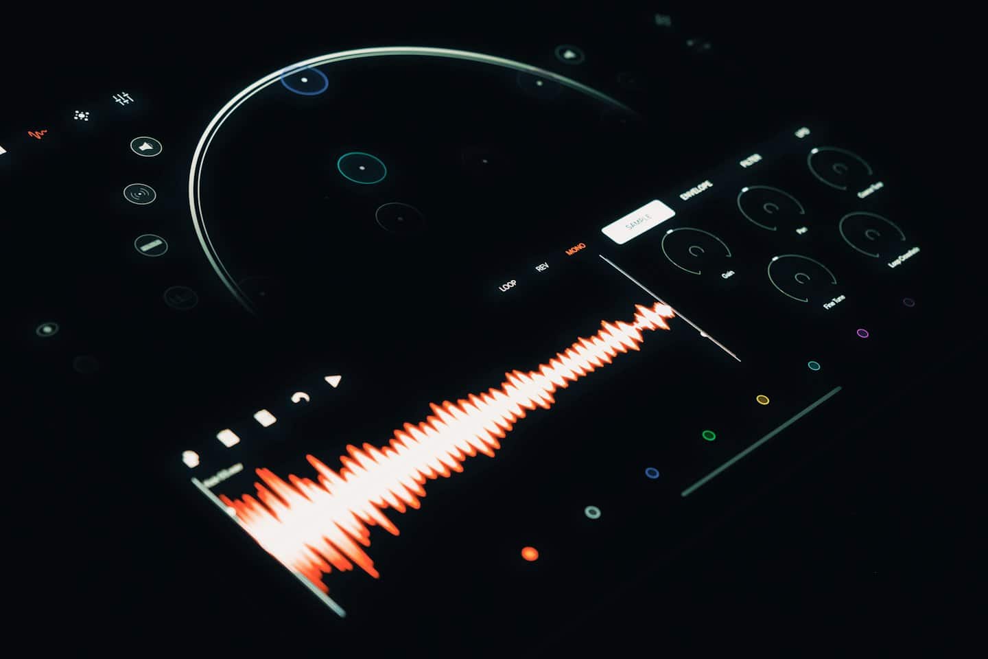 Digital audio workstation interface with orange waveform on dark screen.